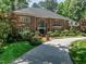 Elegant brick home with a well-manicured lawn and a circular driveway, creating a welcoming curb appeal at 107 Marseille Pl, Cary, NC 27511