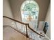 Grand foyer featuring a large arched window, a hanging chandelier and a staircase with wood and white trim at 107 Marseille Pl, Cary, NC 27511