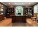 Spacious home office with custom built-ins, rich wood finishes and large arched window at 107 Marseille Pl, Cary, NC 27511