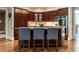 Kitchen with island seating, custom wood cabinets, and stainless-steel appliances at 107 Marseille Pl, Cary, NC 27511