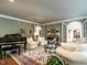 Cozy living room with arched doorways, a piano, comfortable seating, and a decorative rug at 107 Marseille Pl, Cary, NC 27511