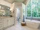 Stunning bathroom with a soaking tub, shower, double vanity and arched window with lots of natural light at 107 Marseille Pl, Cary, NC 27511