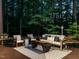 Evening shot of a cozy outdoor patio with comfortable seating and tranquil woodland backdrop at 107 Marseille Pl, Cary, NC 27511
