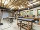 Spacious workshop with overhead lighting, worktables, and tool storage for various projects at 107 Marseille Pl, Cary, NC 27511