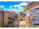 Enclosed backyard featuring a patio set, grill, and garden area under a sunny sky at 1126 Talisker Way, Burlington, NC 27215