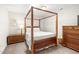Cozy bedroom with a wooden four-poster bed and matching dresser at 1126 Talisker Way, Burlington, NC 27215