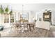 Bright dining room with a large wooden table, seating for six, and an open view into living room with fireplace at 1126 Talisker Way, Burlington, NC 27215