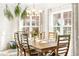Light and airy dining room featuring a wooden table with decorative centerpiece with lots of natural light at 1126 Talisker Way, Burlington, NC 27215