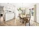 Open dining room with a large wooden table near the kitchen with bright light from nearby windows at 1126 Talisker Way, Burlington, NC 27215