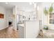 Open kitchen with stainless steel appliances, white cabinets, and a breakfast bar leading into another room at 1126 Talisker Way, Burlington, NC 27215