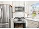 Modern kitchen with stainless steel appliances, white cabinets, subway tile backsplash and a gas range at 1126 Talisker Way, Burlington, NC 27215