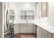 Well-lit kitchen featuring white cabinets, a subway tile backsplash, and stainless-steel appliances at 1126 Talisker Way, Burlington, NC 27215