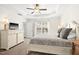 Main bedroom boasts a tray ceiling, ceiling fan, and large double bed at 1126 Talisker Way, Burlington, NC 27215