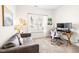 Cozy home office featuring a comfortable couch, workspace, and natural light from the window at 1126 Talisker Way, Burlington, NC 27215