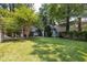 Expansive backyard featuring well-maintained lawn, detached storage shed, and inviting patio area, perfect for outdoor enjoyment at 1200 Glenwood Ave, Raleigh, NC 27605