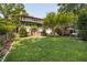 Spacious backyard with lush green lawn and mature trees at 1200 Glenwood Ave, Raleigh, NC 27605