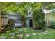 Landscaped backyard featuring a stone pathway and inviting seating area at 1200 Glenwood Ave, Raleigh, NC 27605
