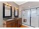 Elegant Primary bathroom with double vanity, granite countertops, and glass shower at 1200 Glenwood Ave, Raleigh, NC 27605