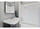 Bathroom with a white tile shower-tub combination and a modern vanity sink at 1200 Glenwood Ave, Raleigh, NC 27605