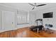 Large bedroom features hardwood floors, a window seat and a modern ceiling fan at 1200 Glenwood Ave, Raleigh, NC 27605