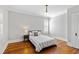 Bright bedroom with hardwood floors, neutral walls, and a cozy bed at 1200 Glenwood Ave, Raleigh, NC 27605