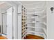 Organized walk-in closet featuring custom shelves for shoes and storage at 1200 Glenwood Ave, Raleigh, NC 27605
