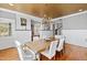 Bright dining room featuring a wooden table, elegant chandelier and wainscoting detail at 1200 Glenwood Ave, Raleigh, NC 27605
