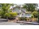 Charming two-story home with a well-maintained lawn and landscaping at 1200 Glenwood Ave, Raleigh, NC 27605