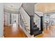Grand foyer with hardwood floors, staircase with carpet runner, and views into the dining room at 1200 Glenwood Ave, Raleigh, NC 27605