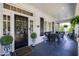 Charming front porch with seating area and decorative plants at 1200 Glenwood Ave, Raleigh, NC 27605