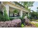 Expansive covered front porch accented with lush landscaping and comfortable seating area at 1200 Glenwood Ave, Raleigh, NC 27605