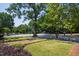 Well-manicured front yard with lush greenery and shade trees at 1200 Glenwood Ave, Raleigh, NC 27605
