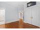 Hallway with hardwood floors, fresh paint, and access to bedrooms and stairway at 1200 Glenwood Ave, Raleigh, NC 27605