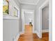 Hallway with hardwood floors, gray walls, and a stained glass window feature at 1200 Glenwood Ave, Raleigh, NC 27605
