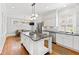 Open concept kitchen with large island, stainless appliances, and eat-in breakfast area at 1200 Glenwood Ave, Raleigh, NC 27605