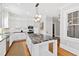 Modern kitchen with a large island, stainless steel appliances, custom cabinets, and granite countertops at 1200 Glenwood Ave, Raleigh, NC 27605