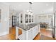 Open kitchen featuring a large island, gas range, breakfast nook, and white cabinetry at 1200 Glenwood Ave, Raleigh, NC 27605