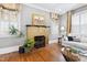 Cozy living room featuring a fireplace, hardwood floors, and natural light at 1200 Glenwood Ave, Raleigh, NC 27605
