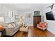 Cozy living room with hardwood floors, neutral paint, shutters, and comfortable seating at 1200 Glenwood Ave, Raleigh, NC 27605