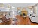 Bright living room with hardwood floors, fireplace, stylish furnishings, and plenty of natural light at 1200 Glenwood Ave, Raleigh, NC 27605
