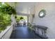 Welcoming brick-walled porch featuring a cozy seating area with rocking chairs and decorative greenery at 1200 Glenwood Ave, Raleigh, NC 27605