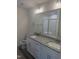 Bathroom features a double sink vanity with a granite countertop and a large mirror at 122 Reece Dr, Sanford, NC 27332