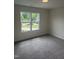 The bedroom features plush carpet, a window with a view and ample natural light at 122 Reece Dr, Sanford, NC 27332