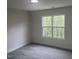 Bright bedroom filled with natural light from a large window overlooking lush greenery at 122 Reece Dr, Sanford, NC 27332