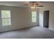 Bright bedroom featuring neutral carpet, two windows and a ceiling fan with great lighting at 122 Reece Dr, Sanford, NC 27332