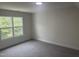 This bedroom features soft carpeting and a bright window with nature views at 122 Reece Dr, Sanford, NC 27332