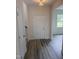 Bright entryway featuring wood-look flooring, a closet and natural light from a window with views of the yard at 122 Reece Dr, Sanford, NC 27332