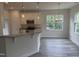 Open concept kitchen featuring granite countertops, a stainless steel microwave and ample natural light at 122 Reece Dr, Sanford, NC 27332