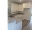 Well-lit kitchen with granite countertops, stainless steel sink and all white cabinetry at 122 Reece Dr, Sanford, NC 27332