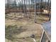 Large, fenced backyard with mature trees providing shade and privacy at 1520 Village Grove Ct, Hillsborough, NC 27278
